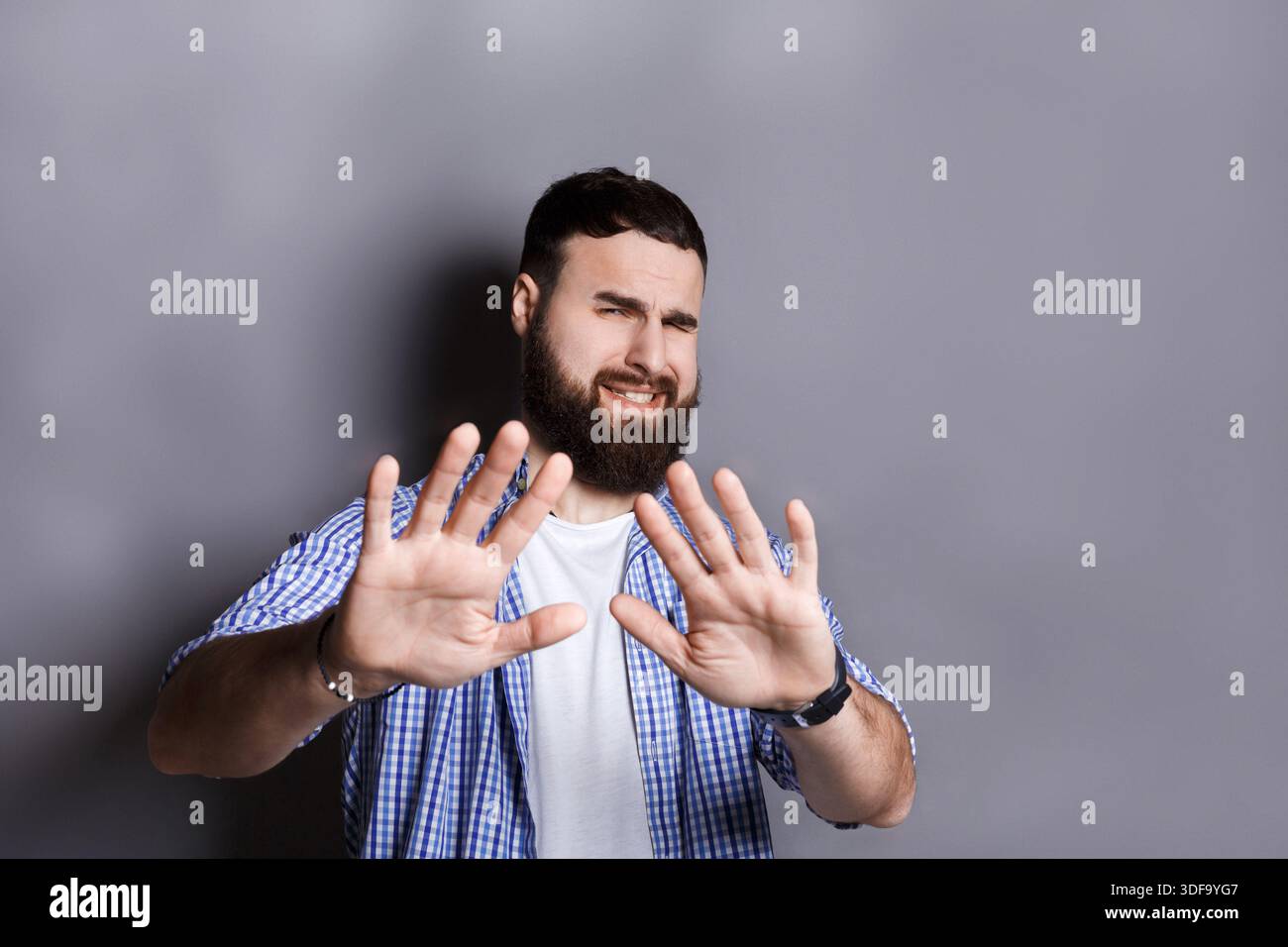 Bearded man expressing disgust, grimacing Stock Photo