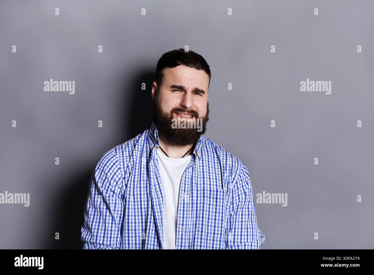 Bearded man expressing disgust, grimacing Stock Photo