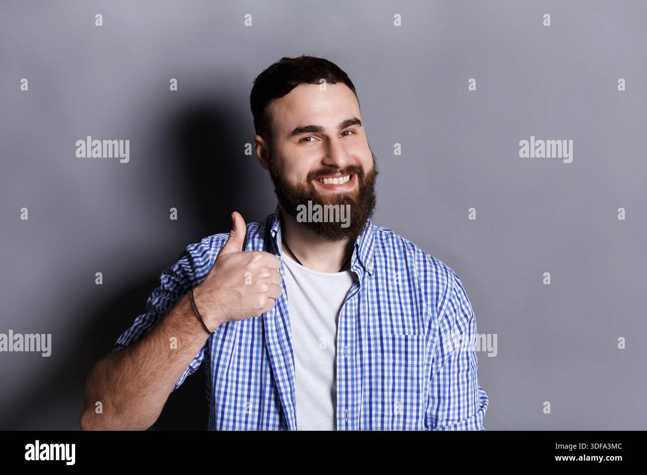 Young hipster man with thumb up portrait Stock Photo
