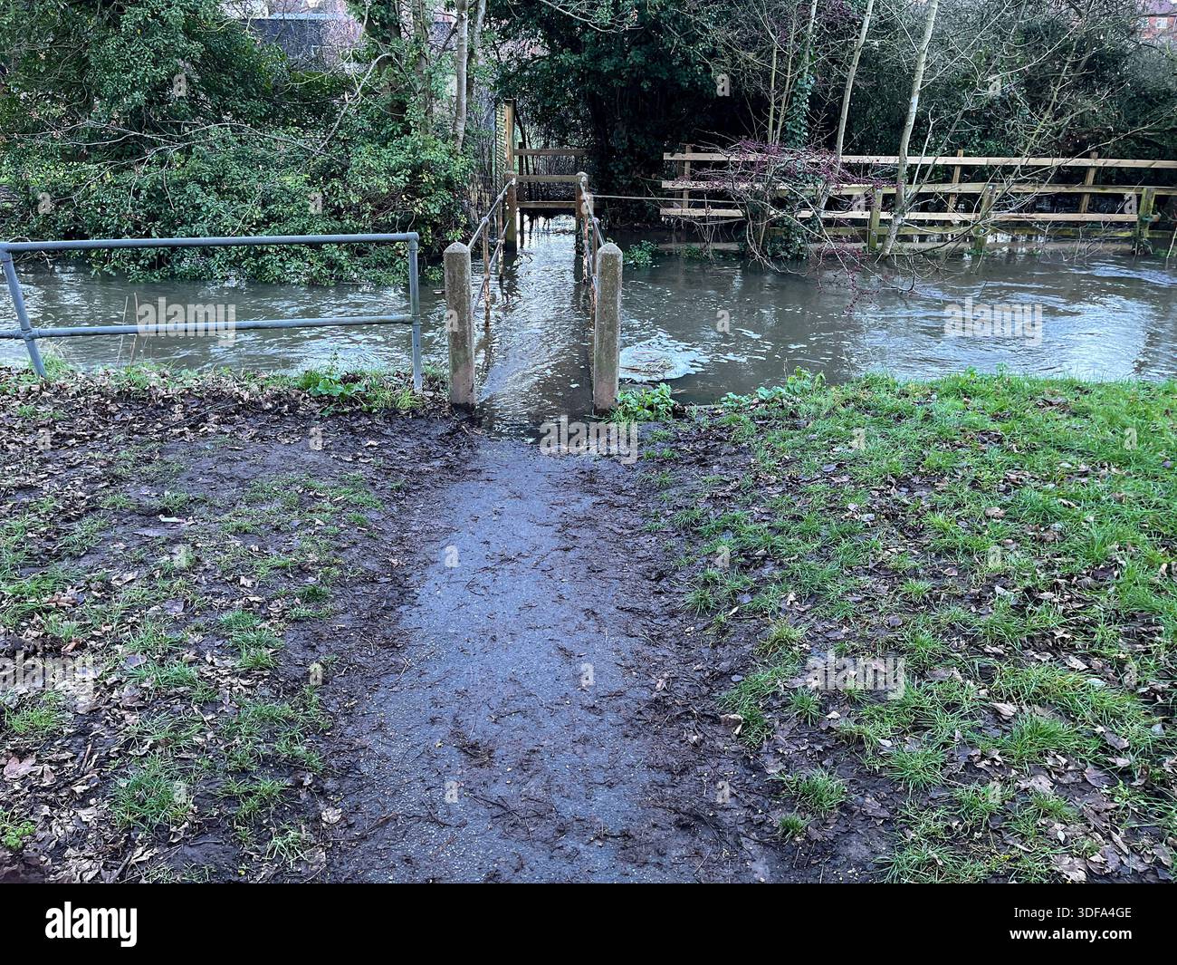 Flooded Footbridge in Rural Landscape with Muddy Water. Flood, flooding in England, Suffolk in January 2026 - Smartphone Captured Stock Image