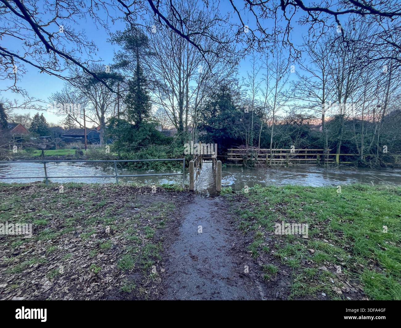 Flooded Footbridge in Rural Landscape with Muddy Water. Flood, flooding in England, Suffolk in January 2026 - Smartphone Captured Stock Image