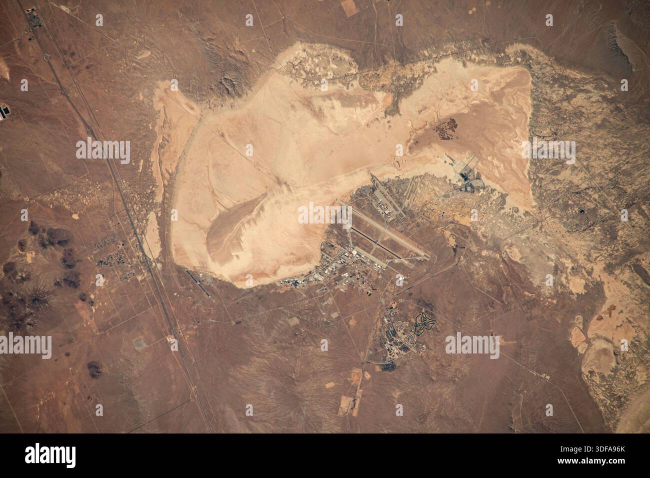 The Edwards Air Force Base complex, which also includes NASA's Neil A. Armstrong Flight Research Center, in California's Mojave Desert is pictured from the International Space Station as it orbited 261 miles above the Golden State. Oct. 26, 2023  An optimised version of an original NASA image: Credit: NASA/JMoghbeli Stock Photo