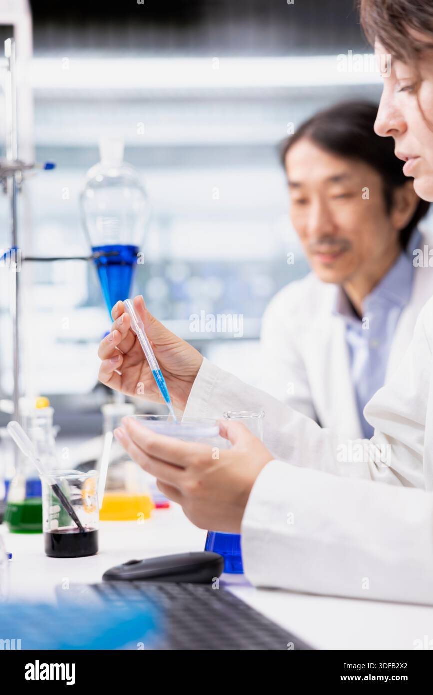 Tech Using Pipette Lab tech doing pipetting pipette hi-res stock photography and images ...