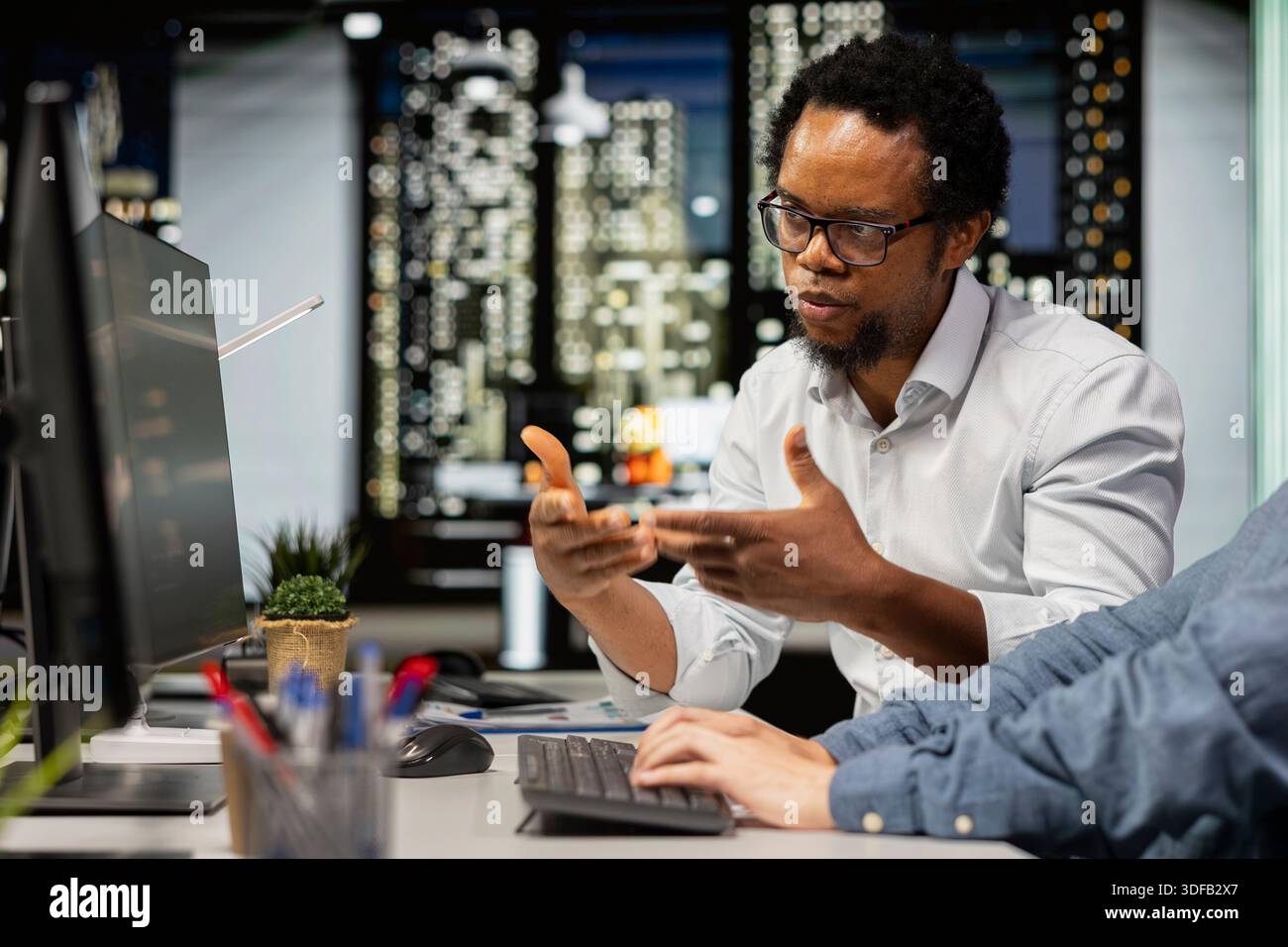 Technicians chatting in startup office, coding advanced machine learning models enhancing automation. Silicon Valley workplace IT specialists discussing, using AI on computer at desk Stock Photo