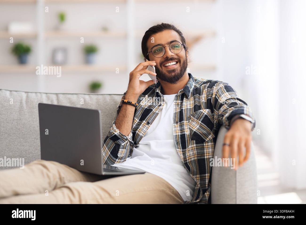 Joyful middle-eastern man freelancer working from home Stock Photo