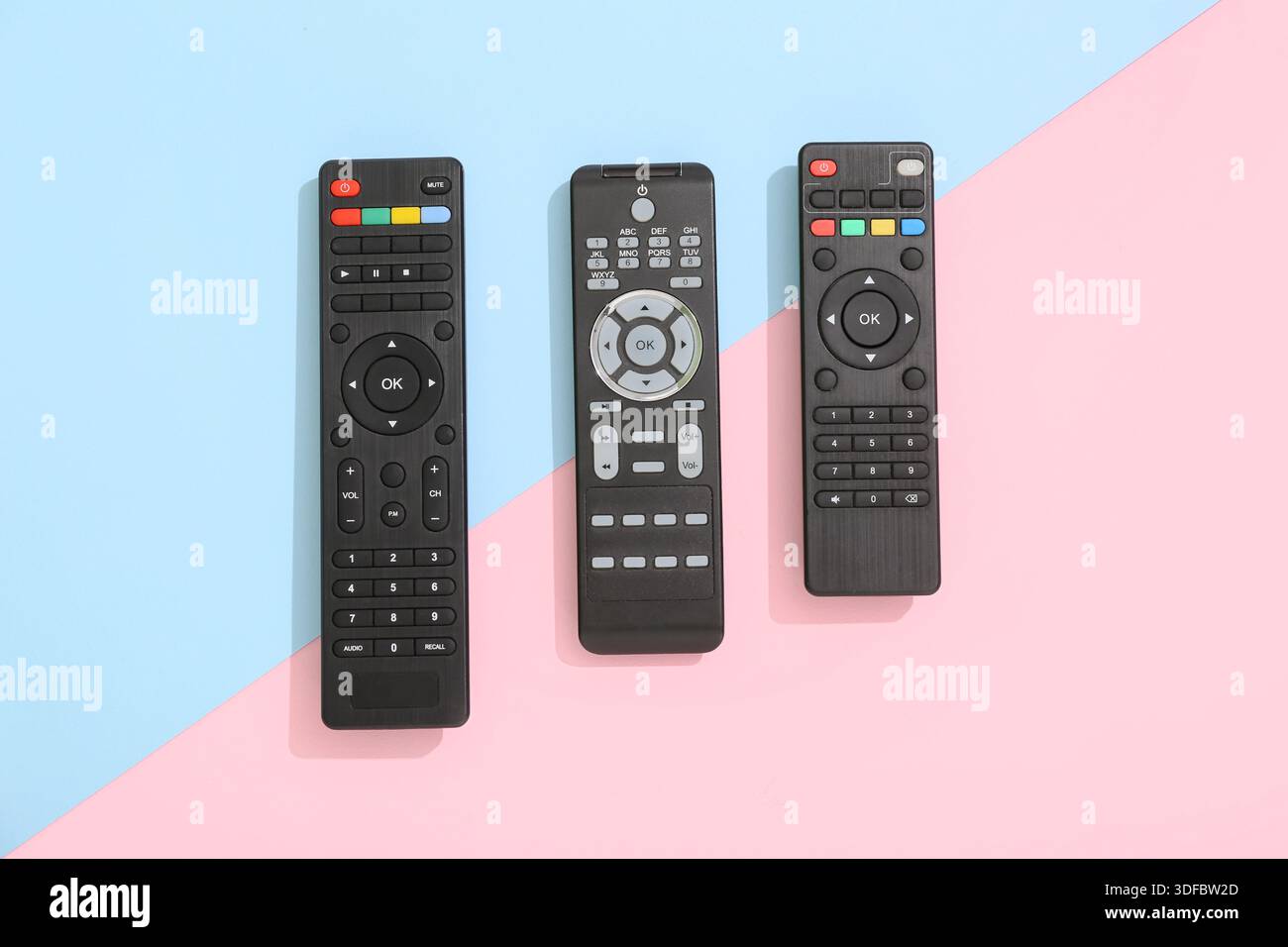 Different modern TV remote controls on color background Stock Photo