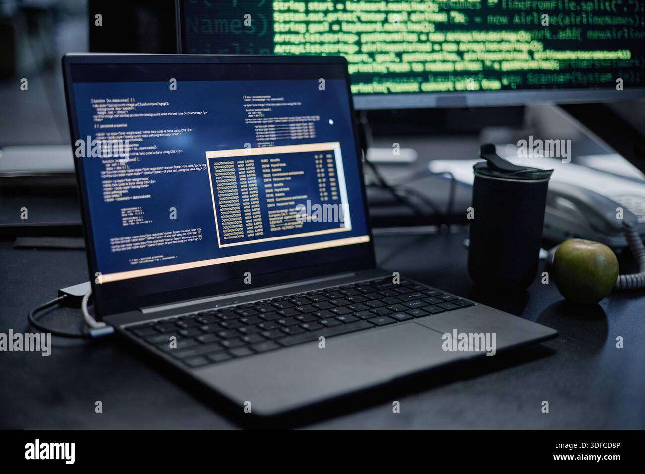 Close up of Laptop Displaying Programming Code in Modern Office Setting Stock Photo