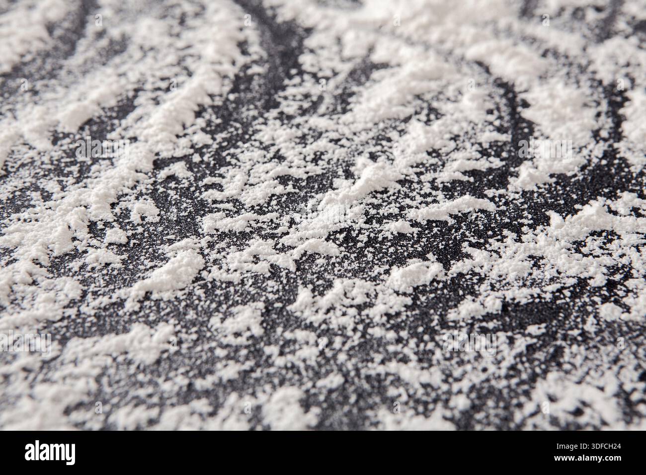 Flour Spread on a Dark Surface Creating a Beautiful Pattern During Baking Preparation Stock Photo