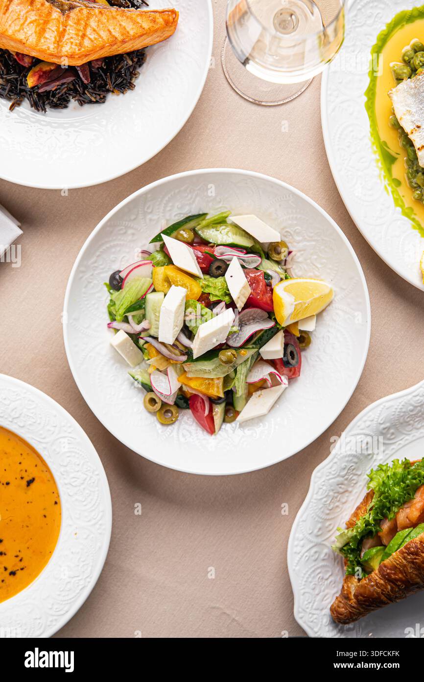 Mediterranean dishes with salad served on table Stock Photo