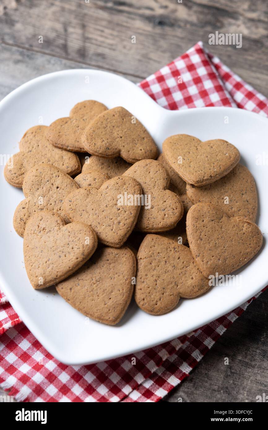 Heart-shaped gingerbread cookies on wooden table Stock Photo