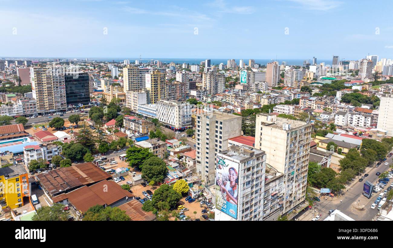 Aerial view of towering buildings casting shadows over bustling streets ...