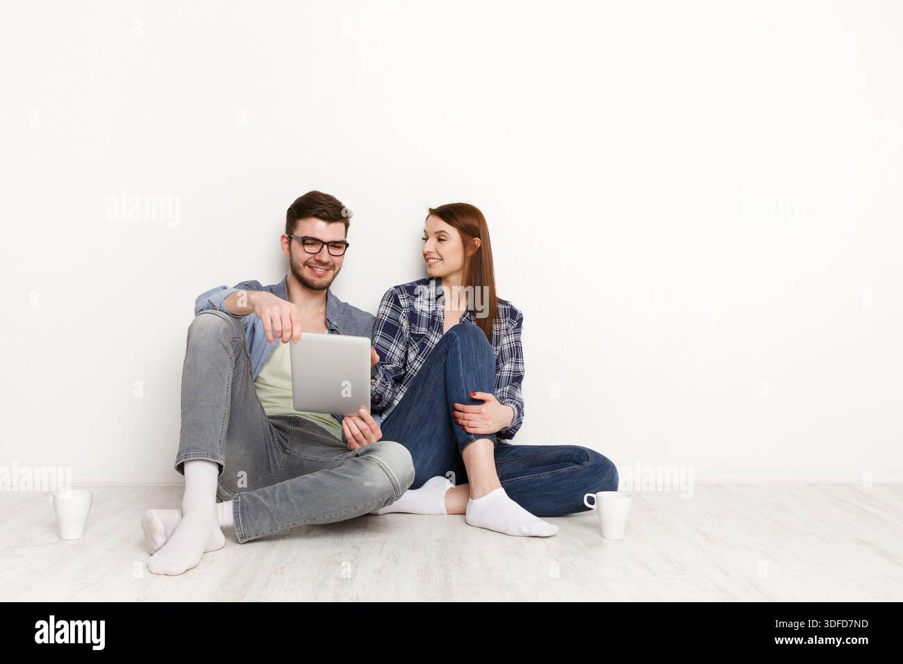 Team work at home with pleasure, couple with digital tablet Stock Photo