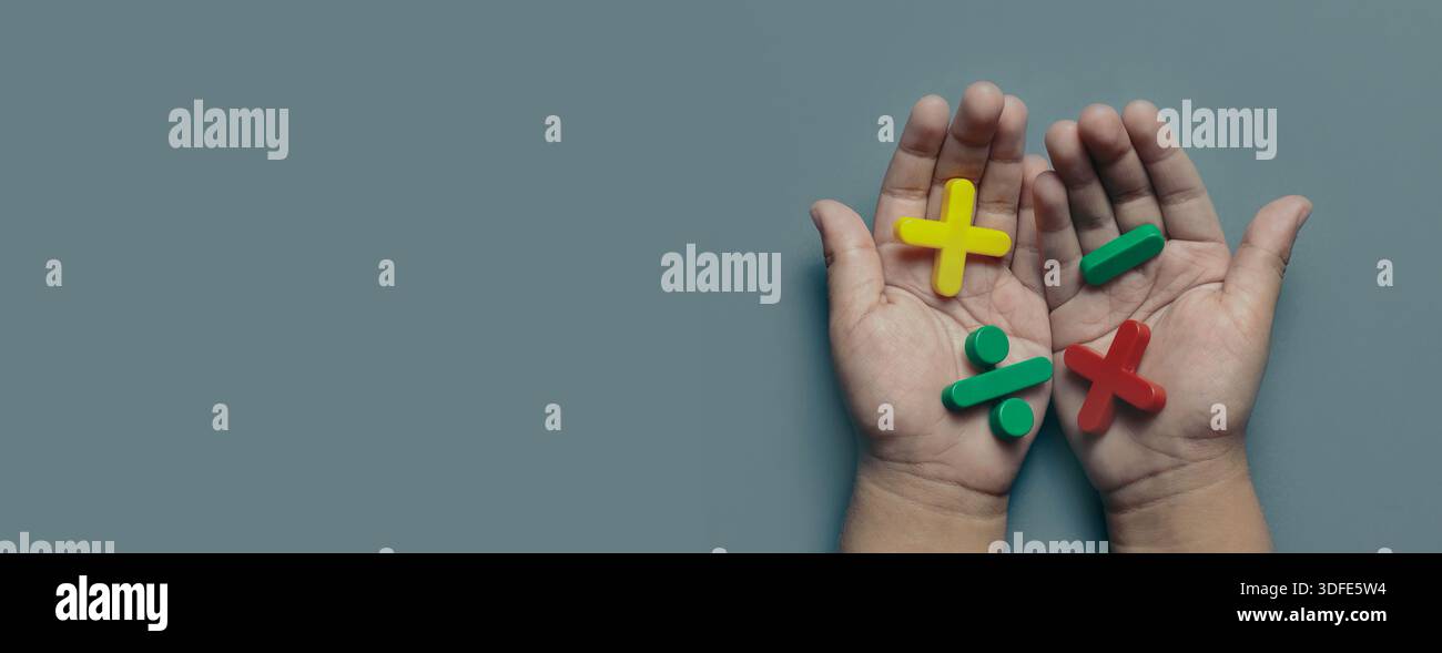 Child Hands Holding Colorful Plus Minus Divide and Multiply Plastic ...