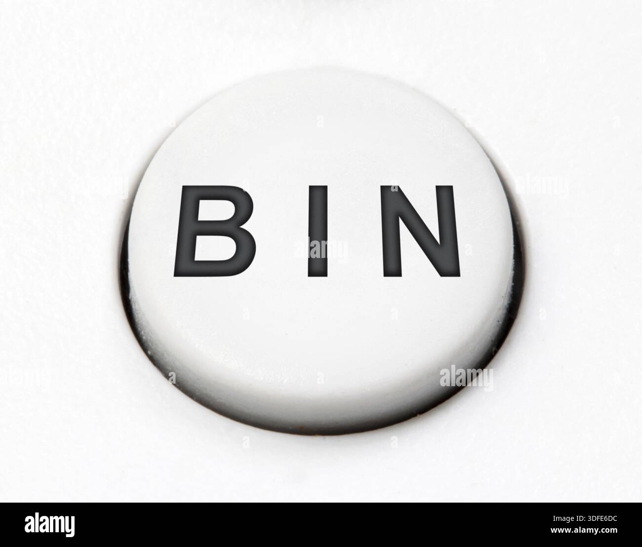 A white round button switch - bin, close up. Control mechanical key for delete on control device Stock Photo