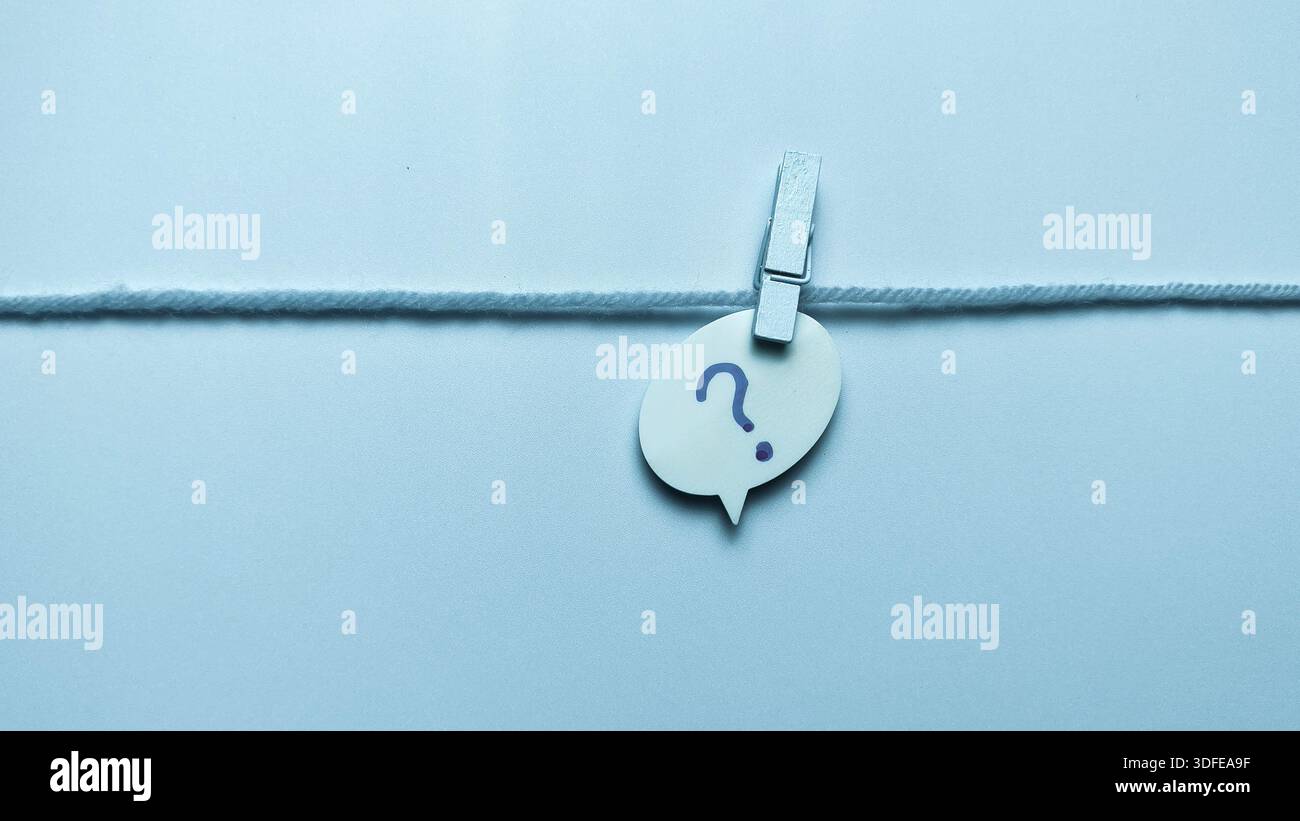 Question Mark Speech Bubble Hanging on String with Clothespin for FAQ and Support Concepts Stock Photo