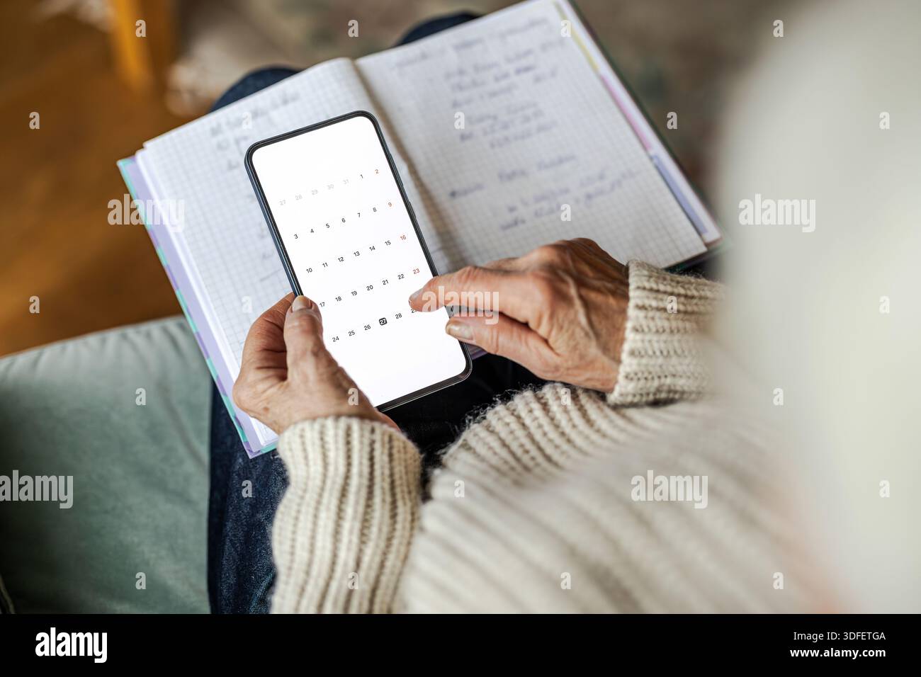 Senior woman using written notes and mobile phone Stock Photo