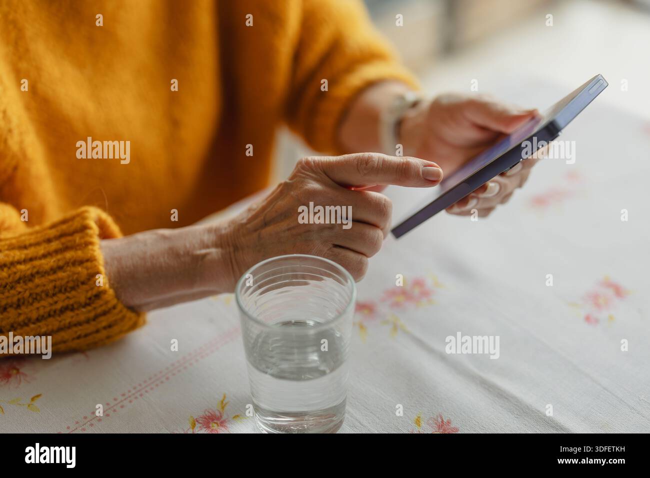 Senior woman using smart phone at home Stock Photo