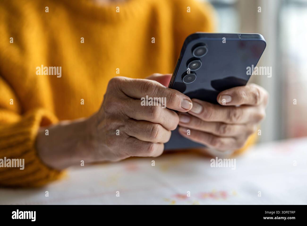 Senior woman using smart phone at home Stock Photo