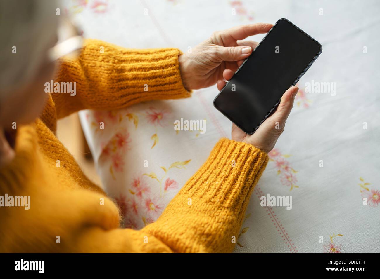 Senior woman using smart phone at home Stock Photo