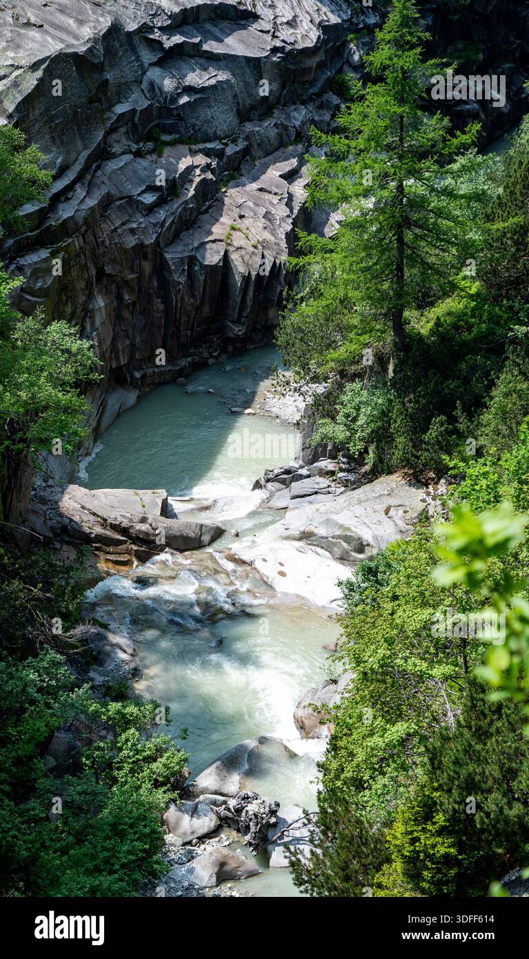 A serene river flowing through a rocky gorge surrounded by lush ...