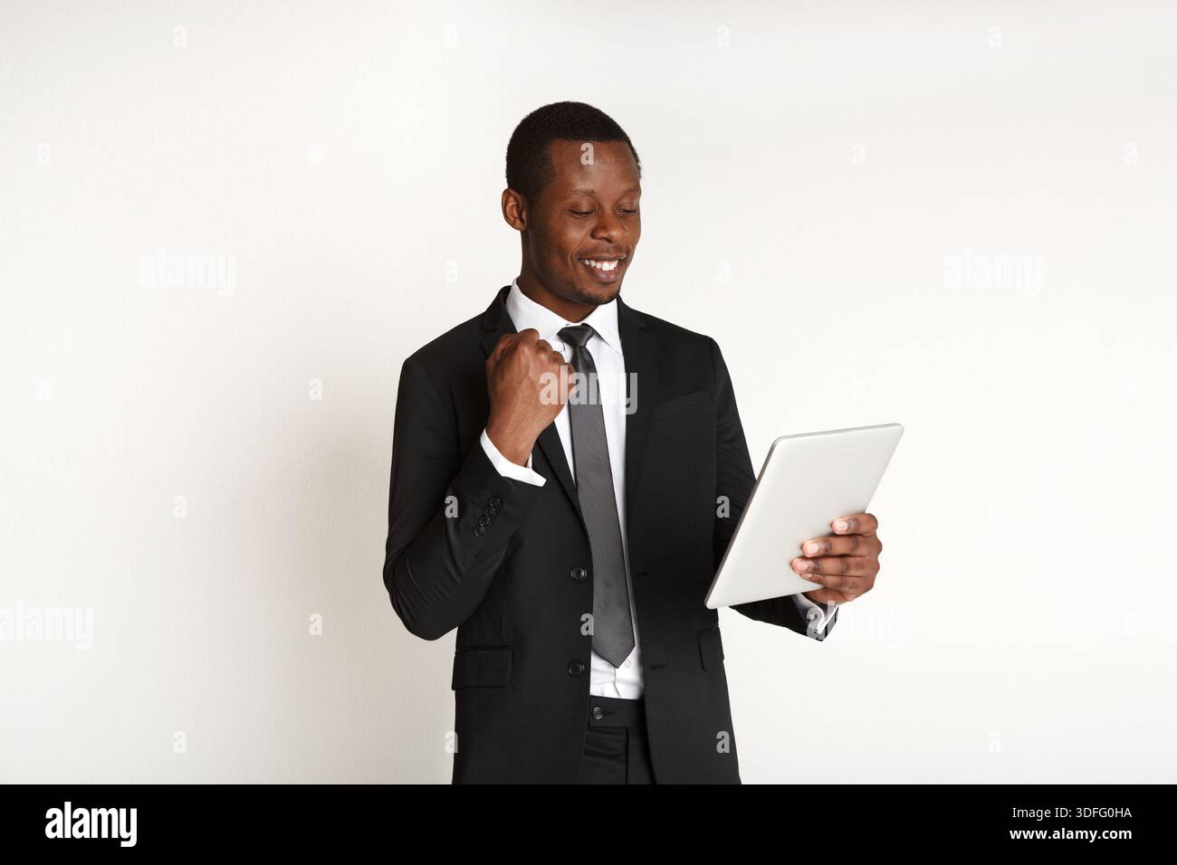 Smiling african american businessman using tablet. Stock Photo