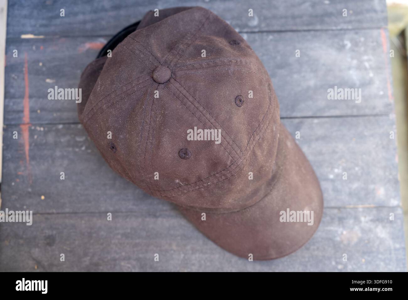 Green cap on a gray cement surface Stock Photo