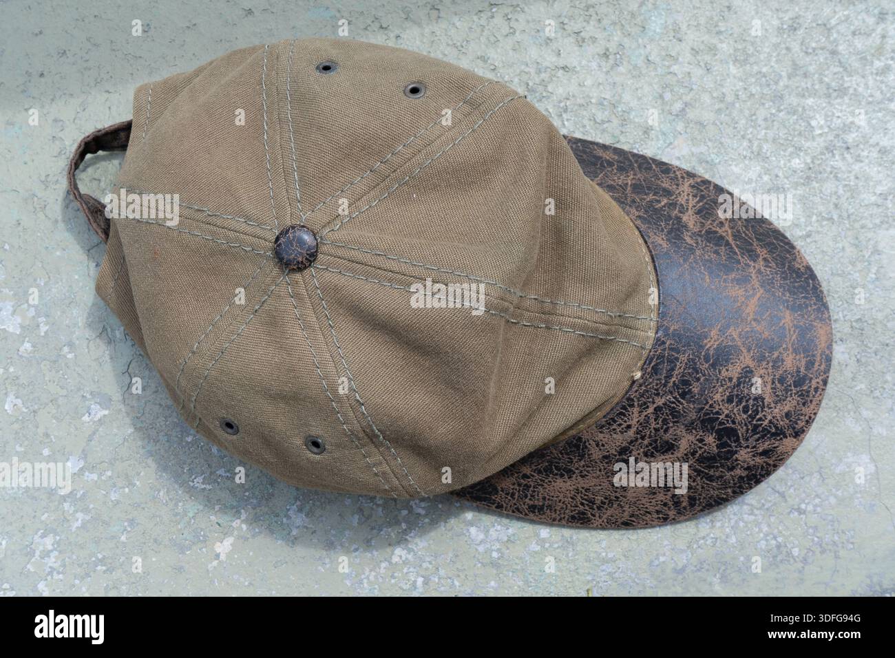 Green cap on a gray cement surface Stock Photo