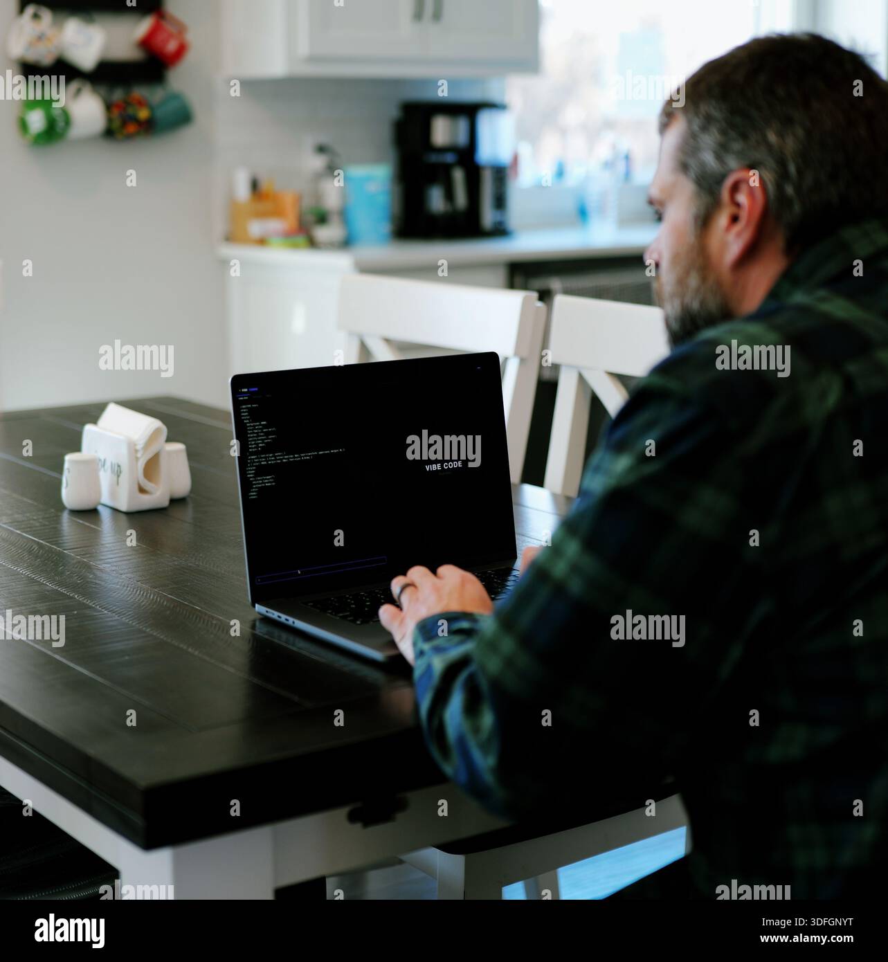 Middle Aged Coder Man Vibe Coding in Artificial Intelligence Infused Integrated Development Environment - Software Engineer Uses AI Based IDE Concept Stock Photo
