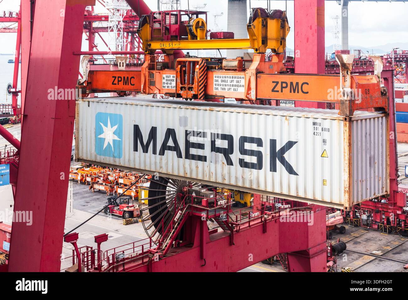 Maersk shipping container lifted by crane during loading operations at ...