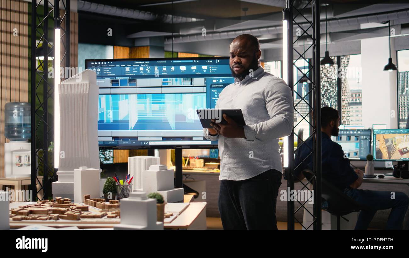 African american real estate developer reviews city planning layout on ...