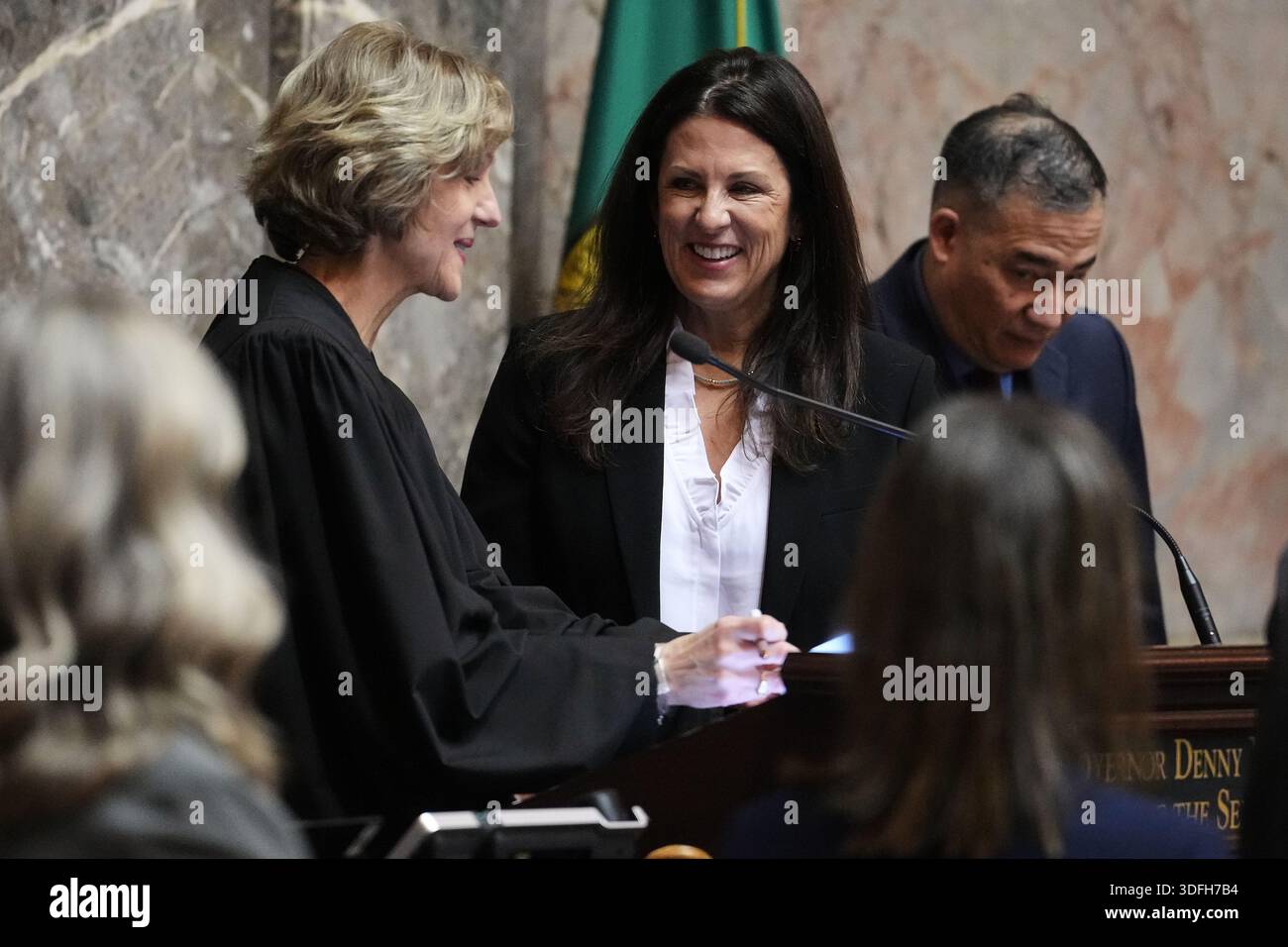 Washington Supreme Court Justice Debra Stephens, left, swears in Sen ...