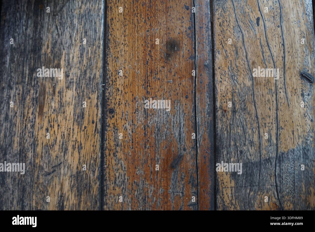 Image showcasing Close-up of aged vertical wood planks with exposed grain, wear marks ...