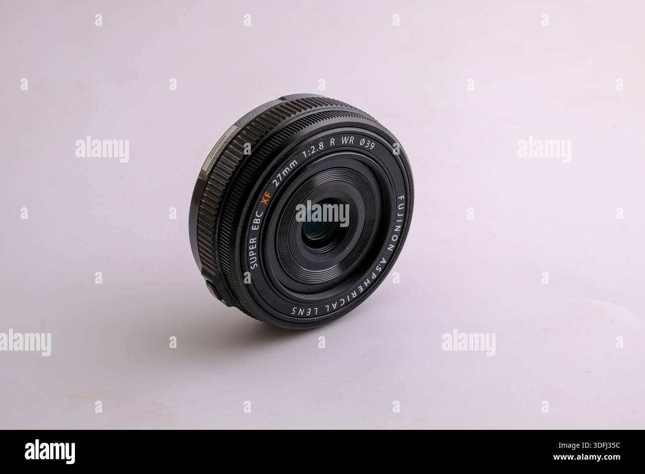 A close-up view of a camera lens on a light background Stock Photo