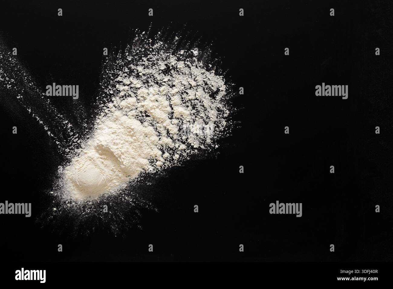 Flour Spread out on a Dark Surface With a Unique Texture and Shape Stock Photo