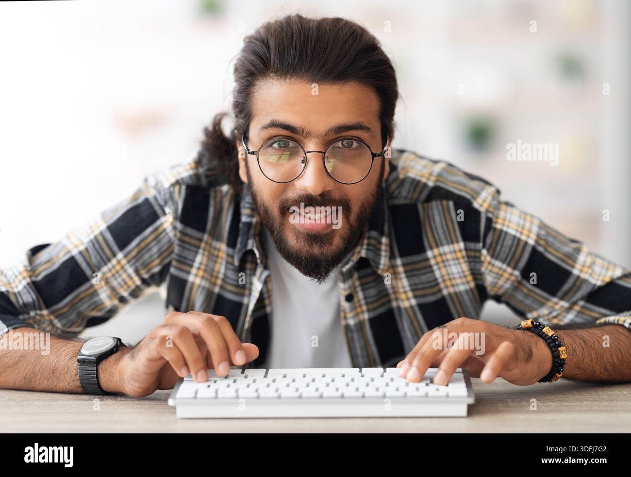 Young middle-eastern man programmer sitting at worktable Stock Photo