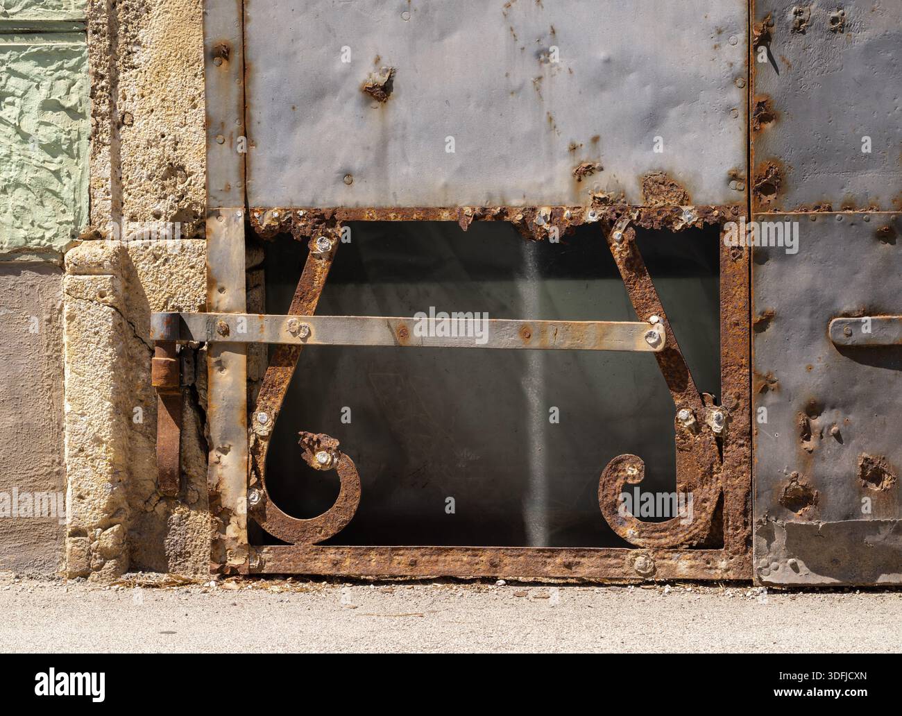 Rusty metal gate with decorative elements and peeling paint Stock Photo