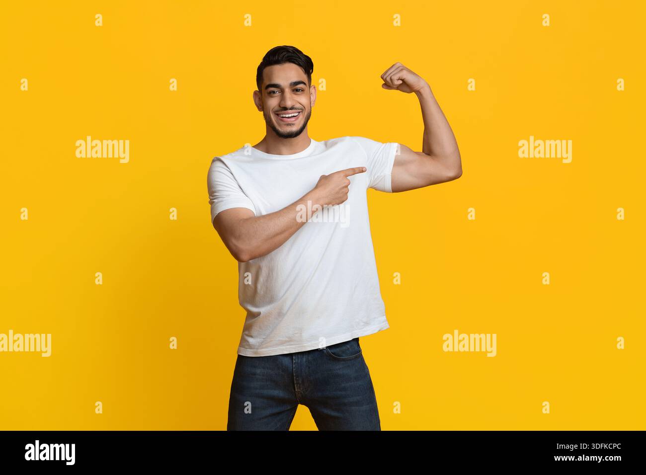 Athletic middle eastern man showing his muscles Stock Photo