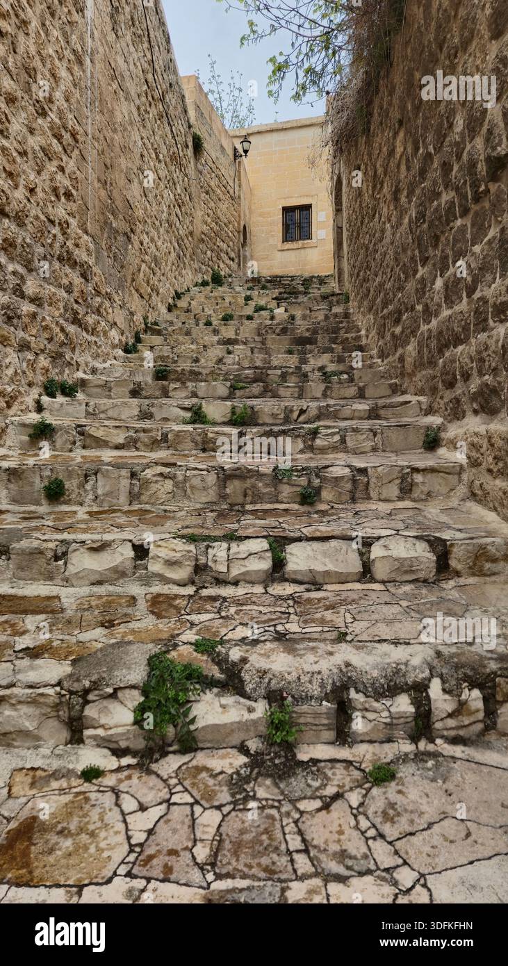 stone paved stairs between old Mardin stone houses in eastern Turkey - Smartphone Captured Stock Image
