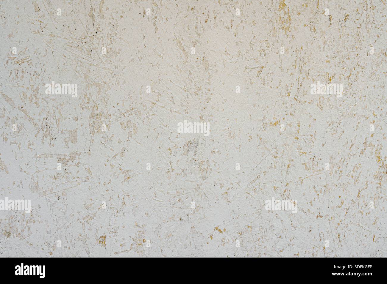 Peeled plaster on the wall. Abstract construction background. Stock Photo
