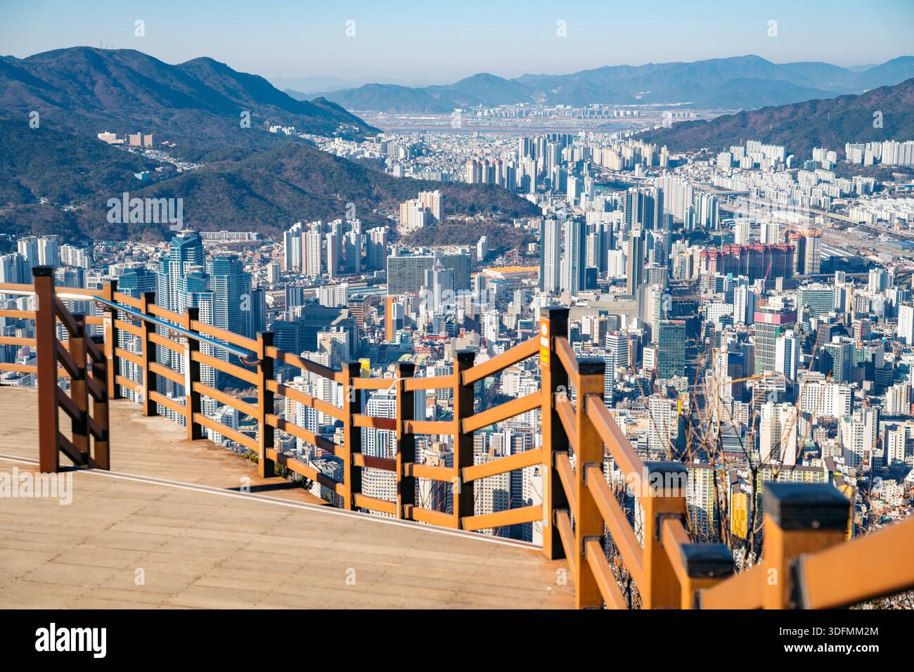 Busan cityscape viewed from a wooden observation deck with a railing. Stock Photo
