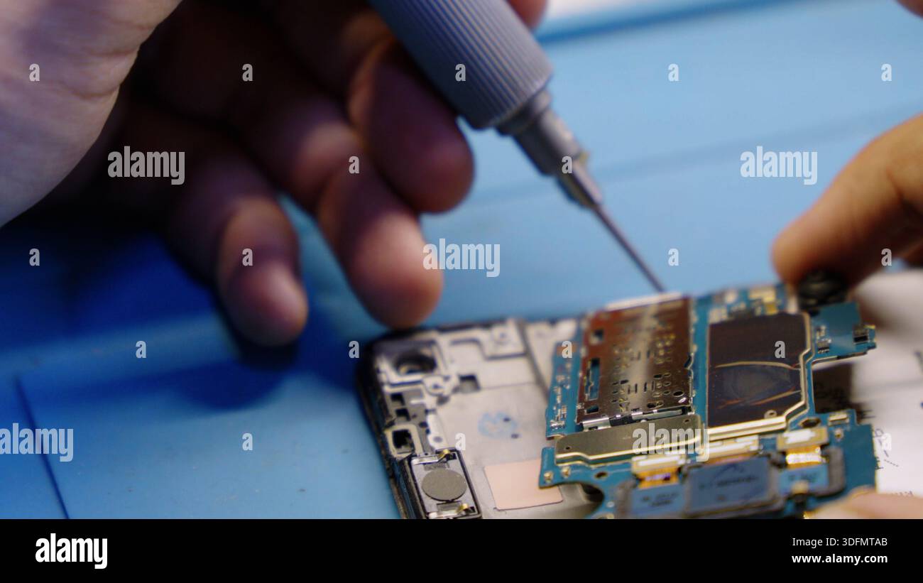 Soldering electronic components on phone Stock Photo