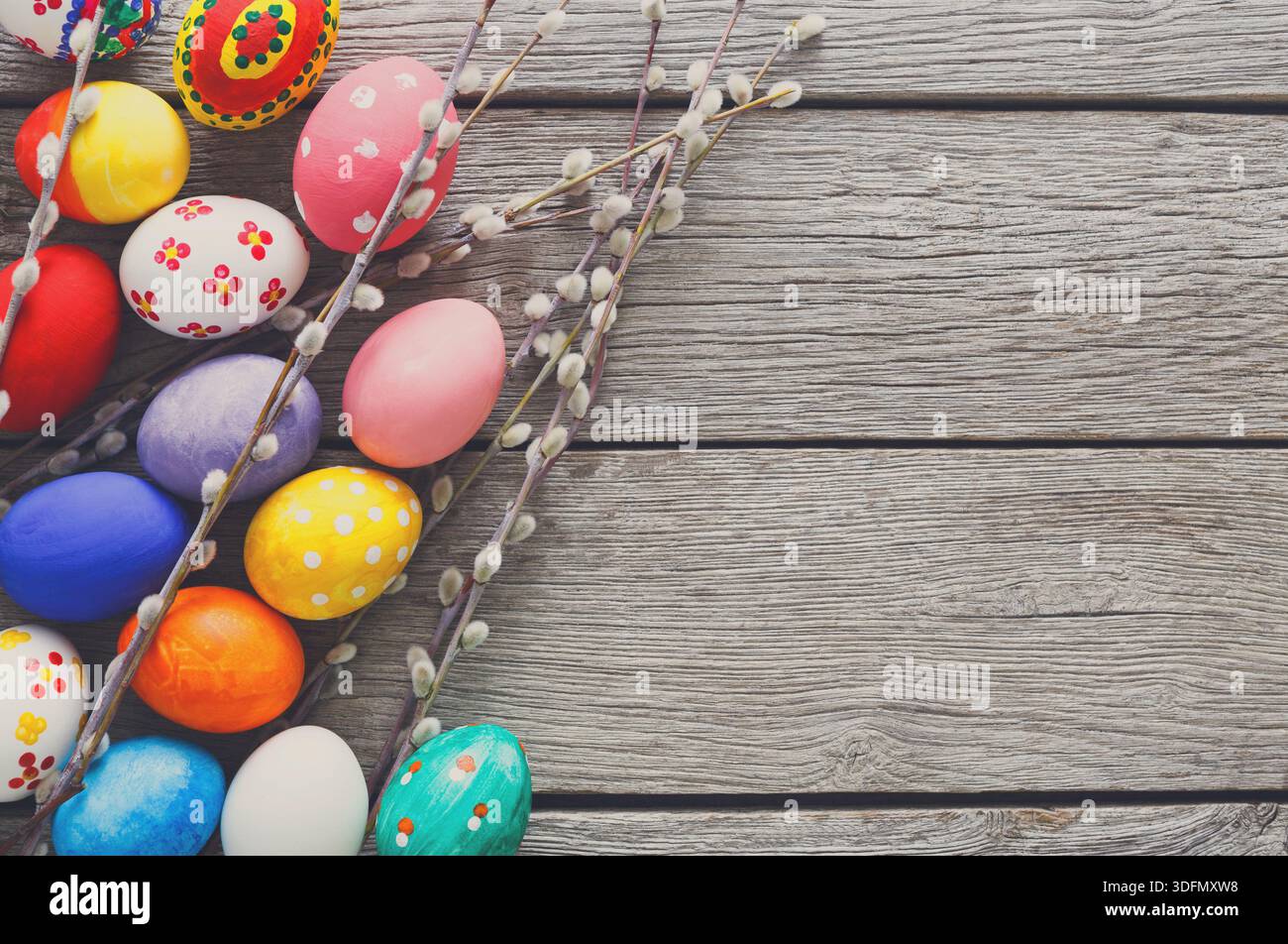 Colorful Easter Eggs Arranged With Delicate Branches on a Rustic Wooden Table Stock Photo
