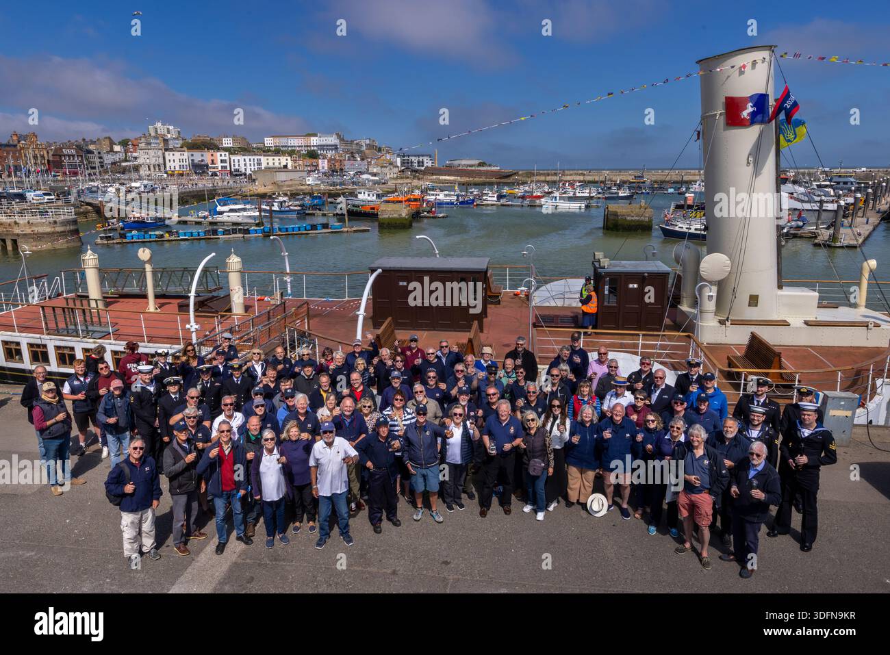 Skippers, owners and crew of the Little Ships assemble with members of the Royal Navy by the Medway Queen for a Rum Tot,  part of the 85th  Anniversar Stock Photo