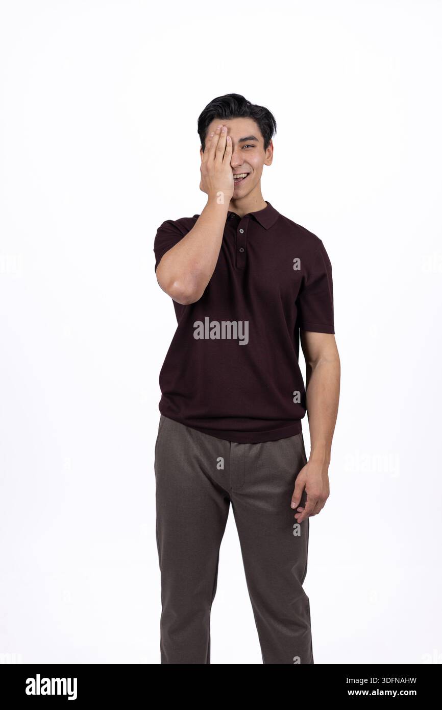 Young Man Touching His Face and Appearing Thoughtful or Surprised Stock Photo