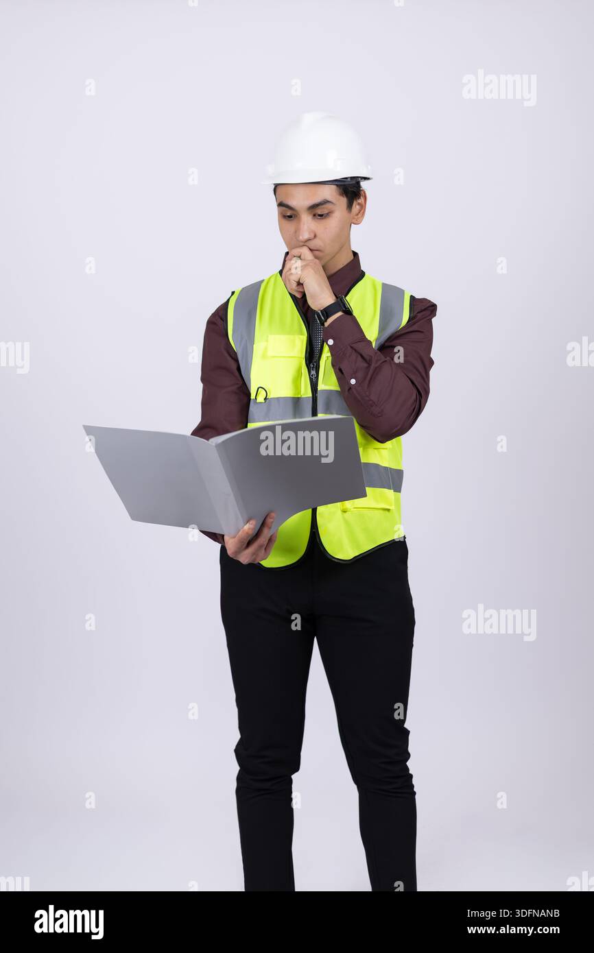 Professional Engineer in Safety Equipment Using Laptop for Project Management Stock Photo