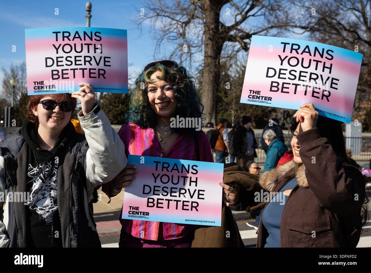 People hold signs that say 