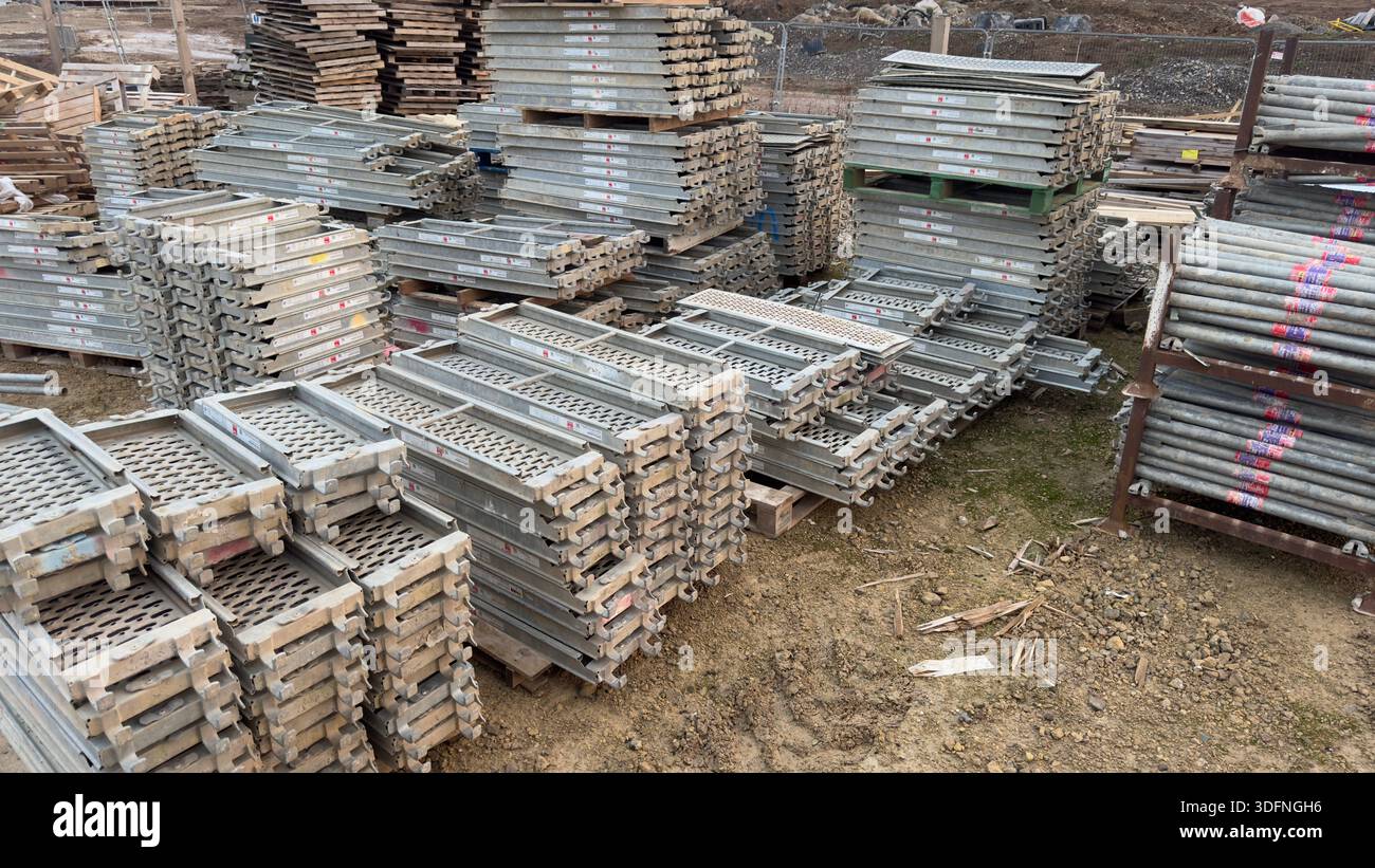 A large outdoor storage area filled with stacks of metal scaffolding ...