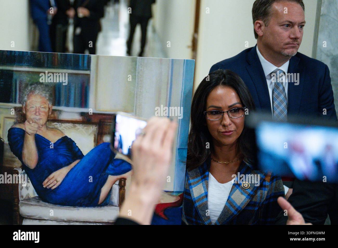 U.S. Rep. Lauren Boebert (R-CO) holds up an image of former U.S. President  Bill Clinton allegedly displayed in the home of Jeffrey Epstein as members  of the House Oversight Committee hold a