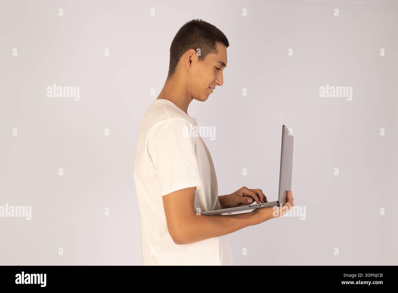 Man using laptop in profile Stock Photo