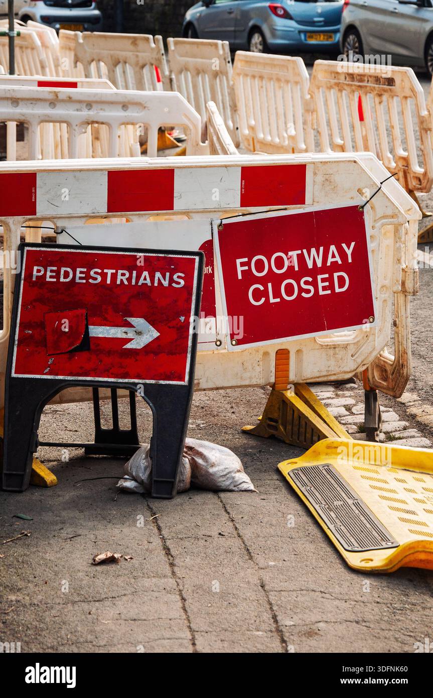Redirection Signage Pedestrians and footway closed due to roadworks. Temporary barriers and ...